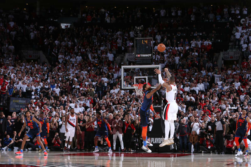 PORTLAND, OR - APRIL 23: Damian Lillard #0 of the Portland Trail Blazers shoots the three-point shot to win the game against Paul George #13 of the Oklahoma City Thunder during Game Five of Round One of the 2019 NBA Playoffs on April 23, 2019 at the Moda Center in Portland, Oregon. NOTE TO USER: User expressly acknowledges and agrees that, by downloading and or using this Photograph, user is consenting to the terms and conditions of the Getty Images License Agreement. Mandatory Copyright Notice: Copyright 2019 NBAE (Photo by Sam Forencich/NBAE via Getty Images)